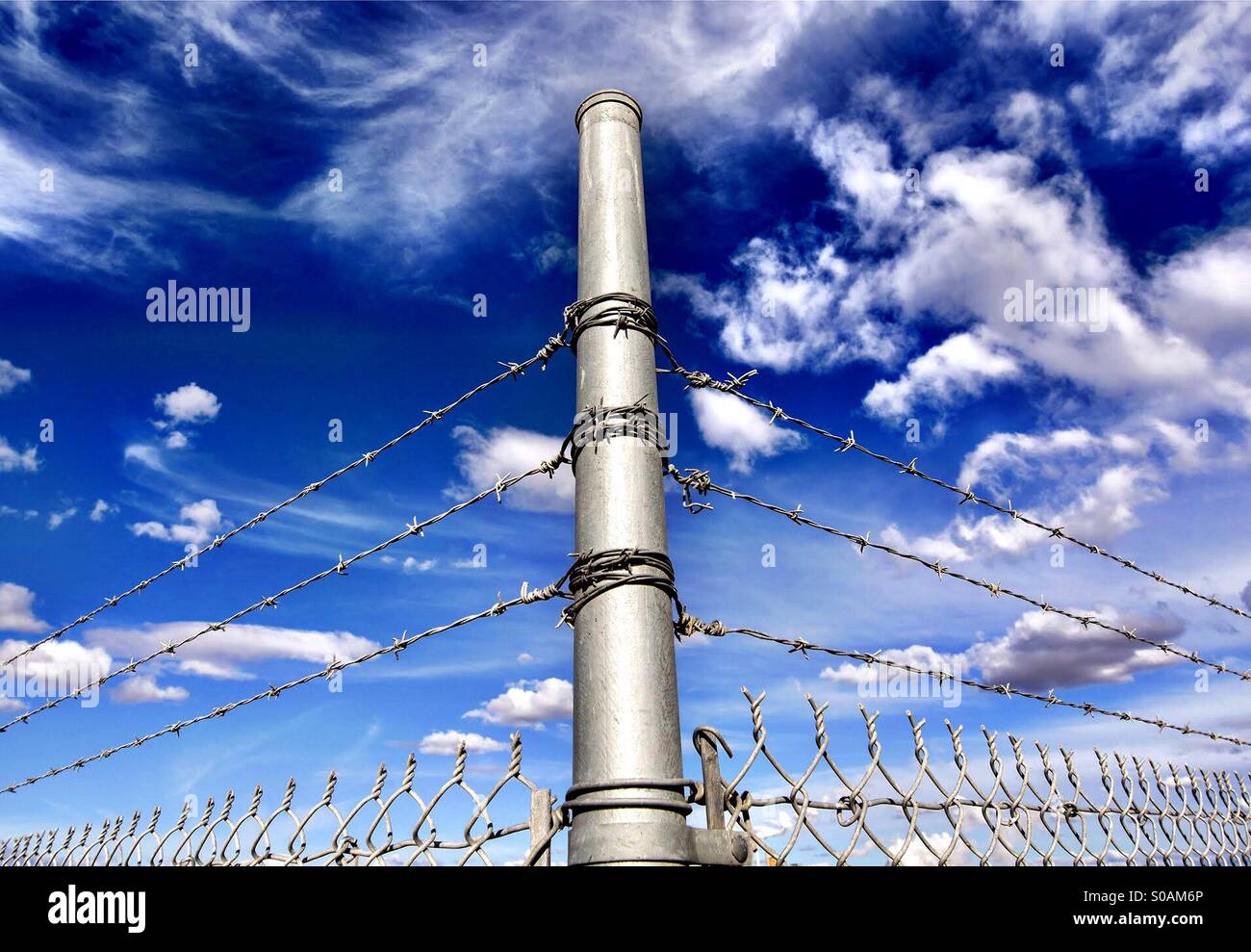 A corner post of a barbed wire fence Stock Photo Alamy