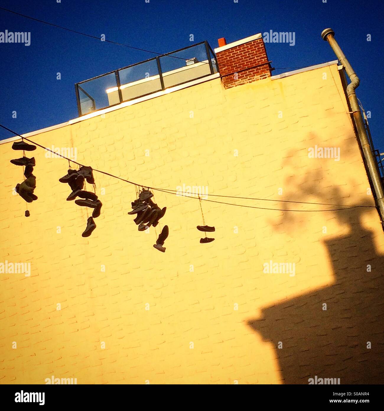 Sneakers hanging from a wire in New York City Stock Photo Alamy
