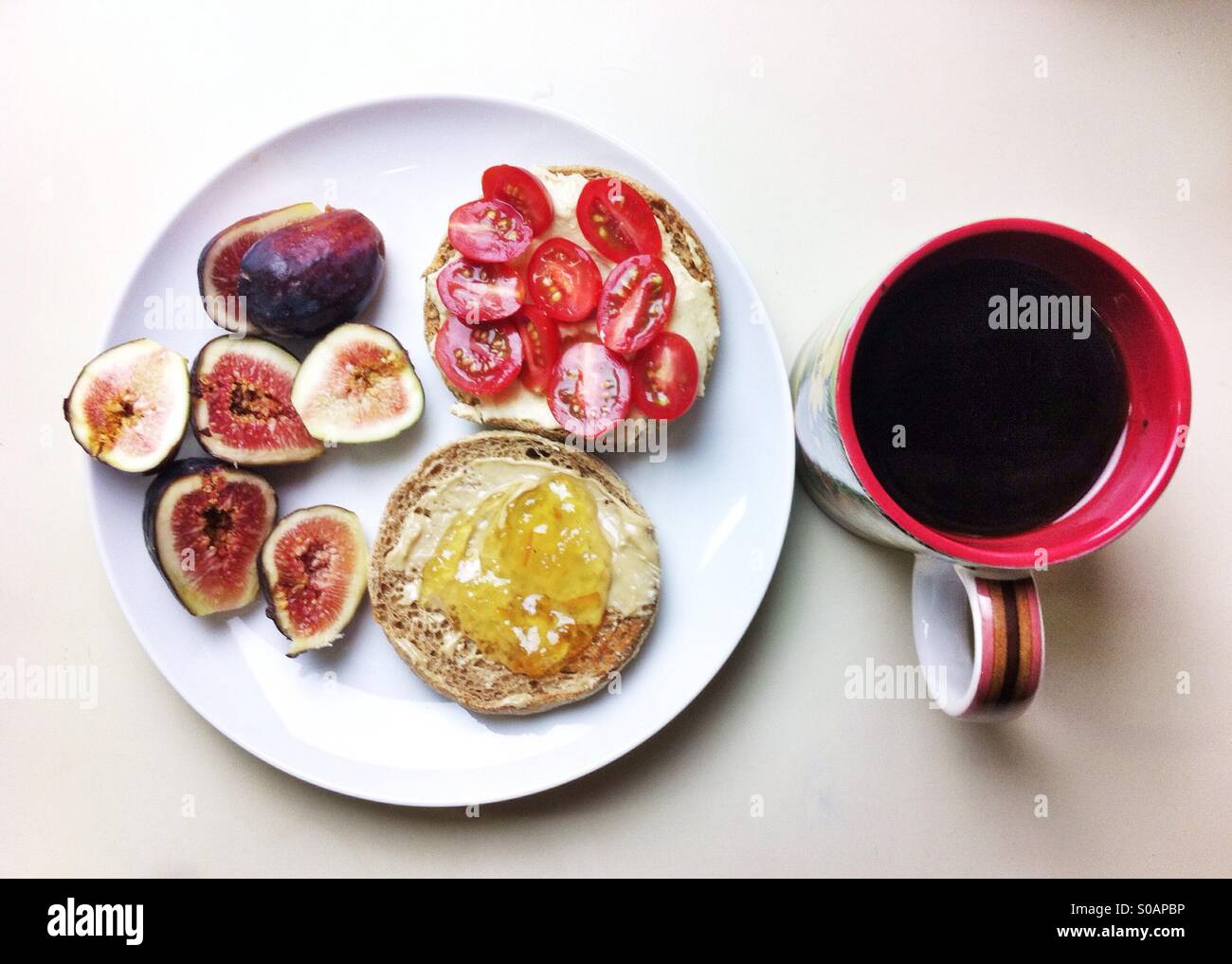 Vegan breakfast with coffee, fresh figs, muffins, hummus, tomatoes and jam - Smartphone Captured Stock Image