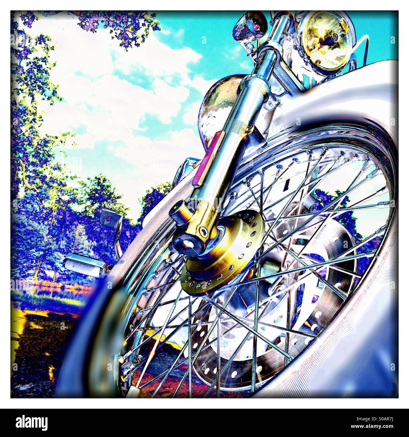 Digitally altered image showing front of chopper motorcycle in psychedelic colouring Stock Photo