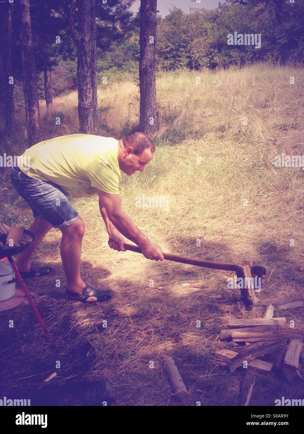Young man chopping wood - Smartphone Captured Stock Image