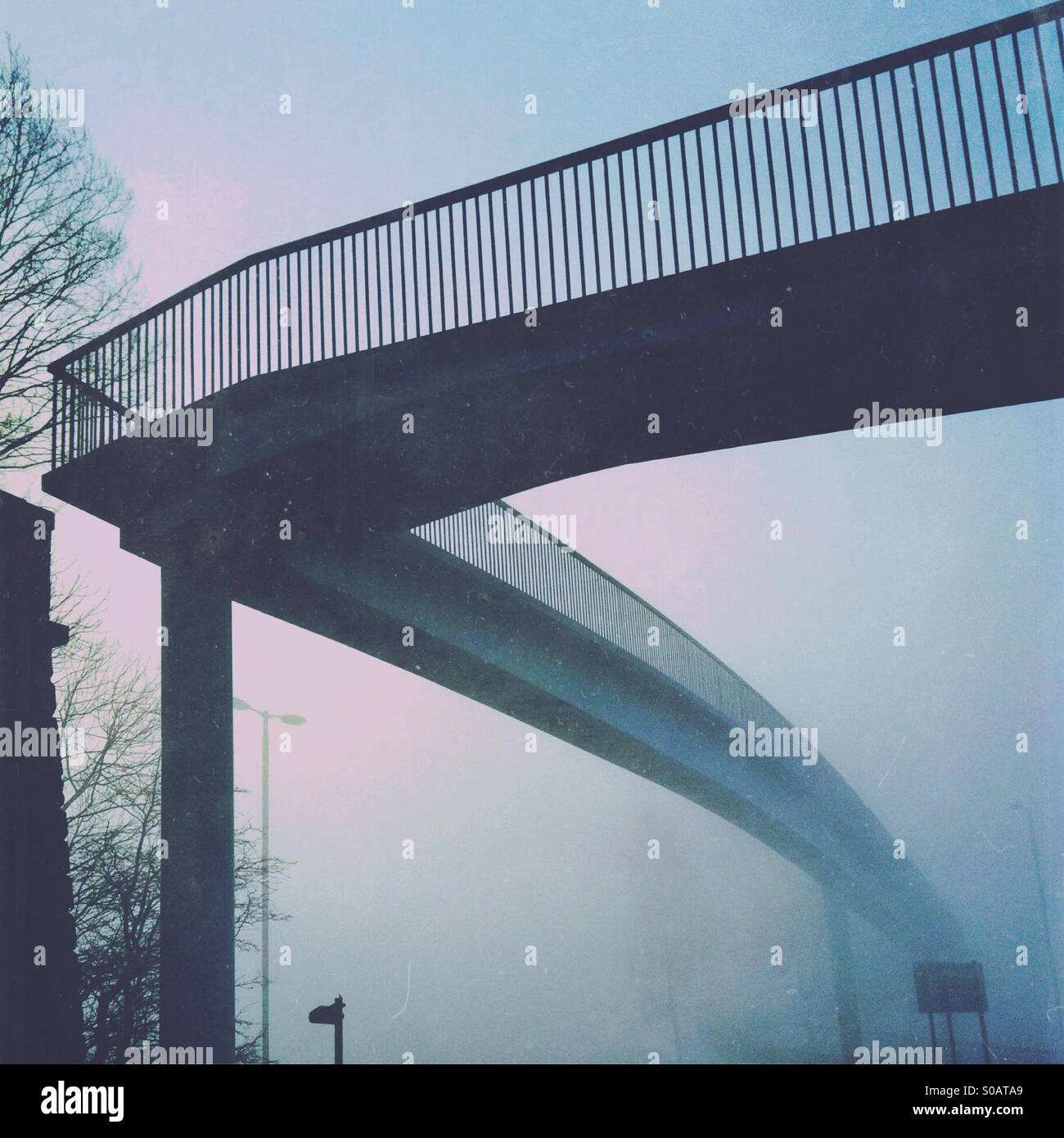 Footbridge in fog. Stock Photo