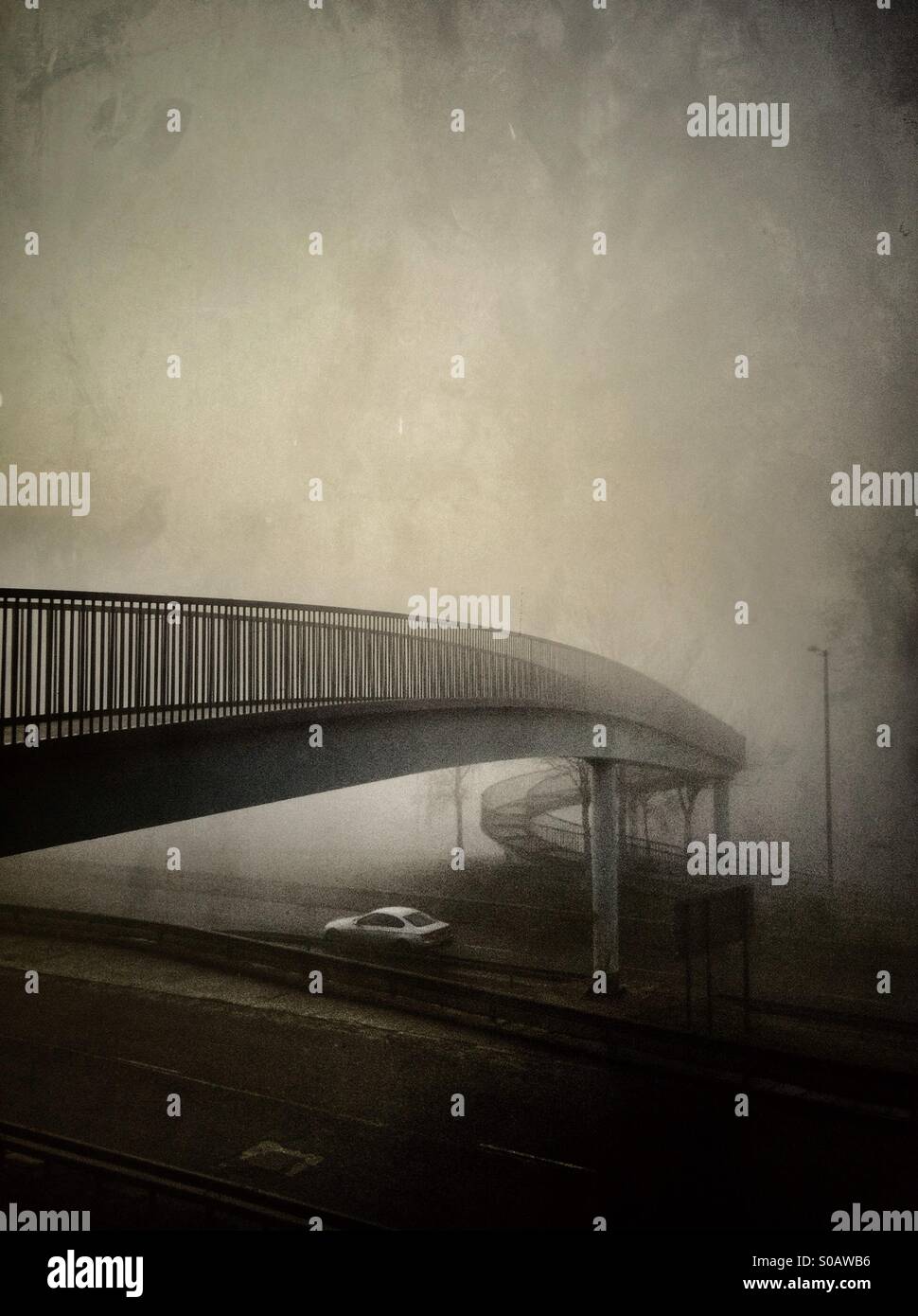 Car under bridge in fog. Stock Photo
