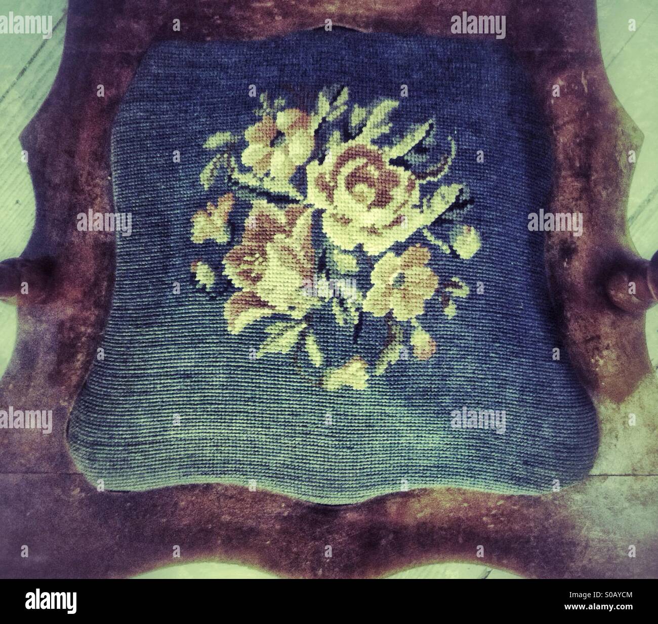 Vintage needlepoint chair cushion - Smartphone Captured Stock Image