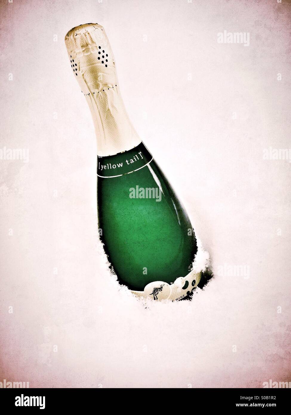 Bottle of bubbly (sparkling wine) being chilled in the snow. - Smartphone Captured Stock Image