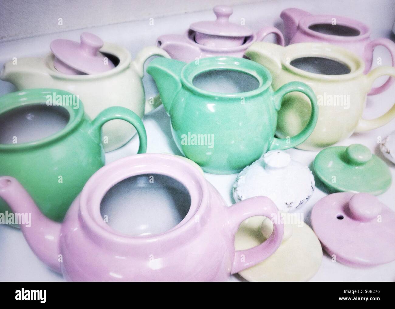 Lavender, pink and mint green teapots on a countertop - Smartphone Captured Stock Image