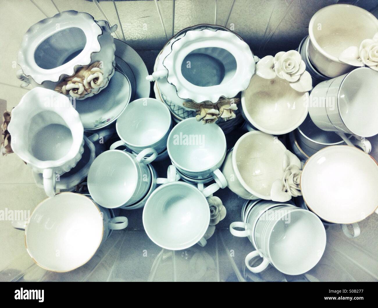 Porcelain tea cups and sugar bowls in a plastic box - Smartphone Captured Stock Image