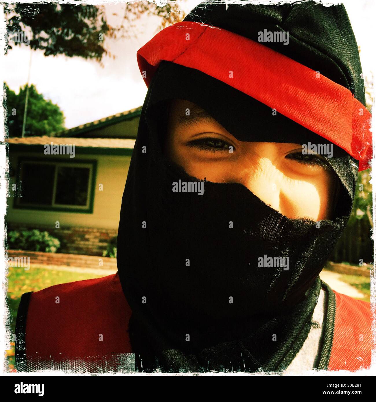 Six year old boy smiling in his Ninja Halloween costume. - Smartphone Captured Stock Image