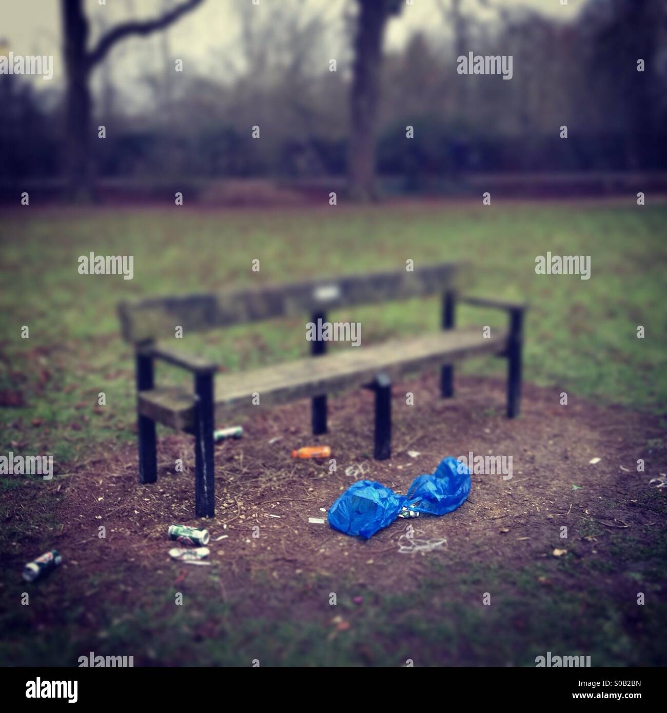 Rubbish by a bench Stock Photo