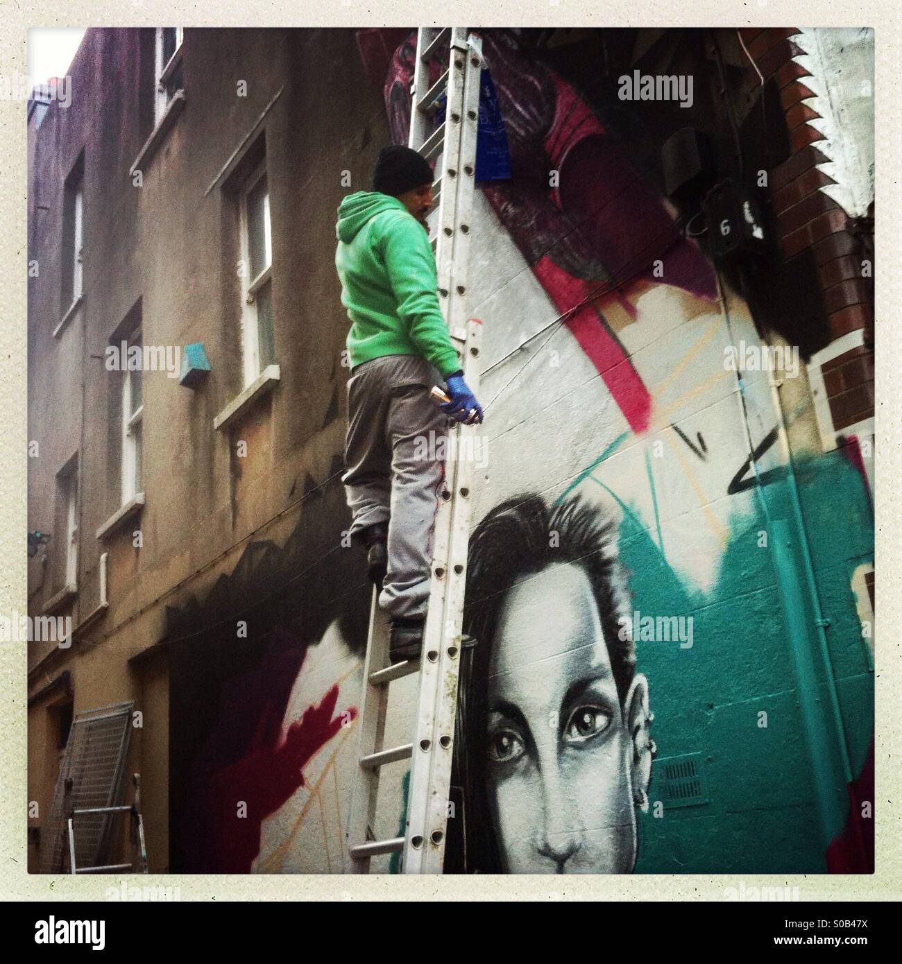 Graffiti artist at work - Smartphone Captured Stock Image