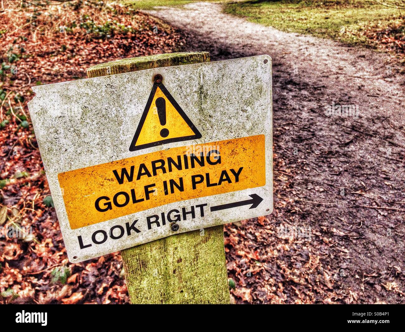 Sign warning of golf in play Stock Photo Alamy