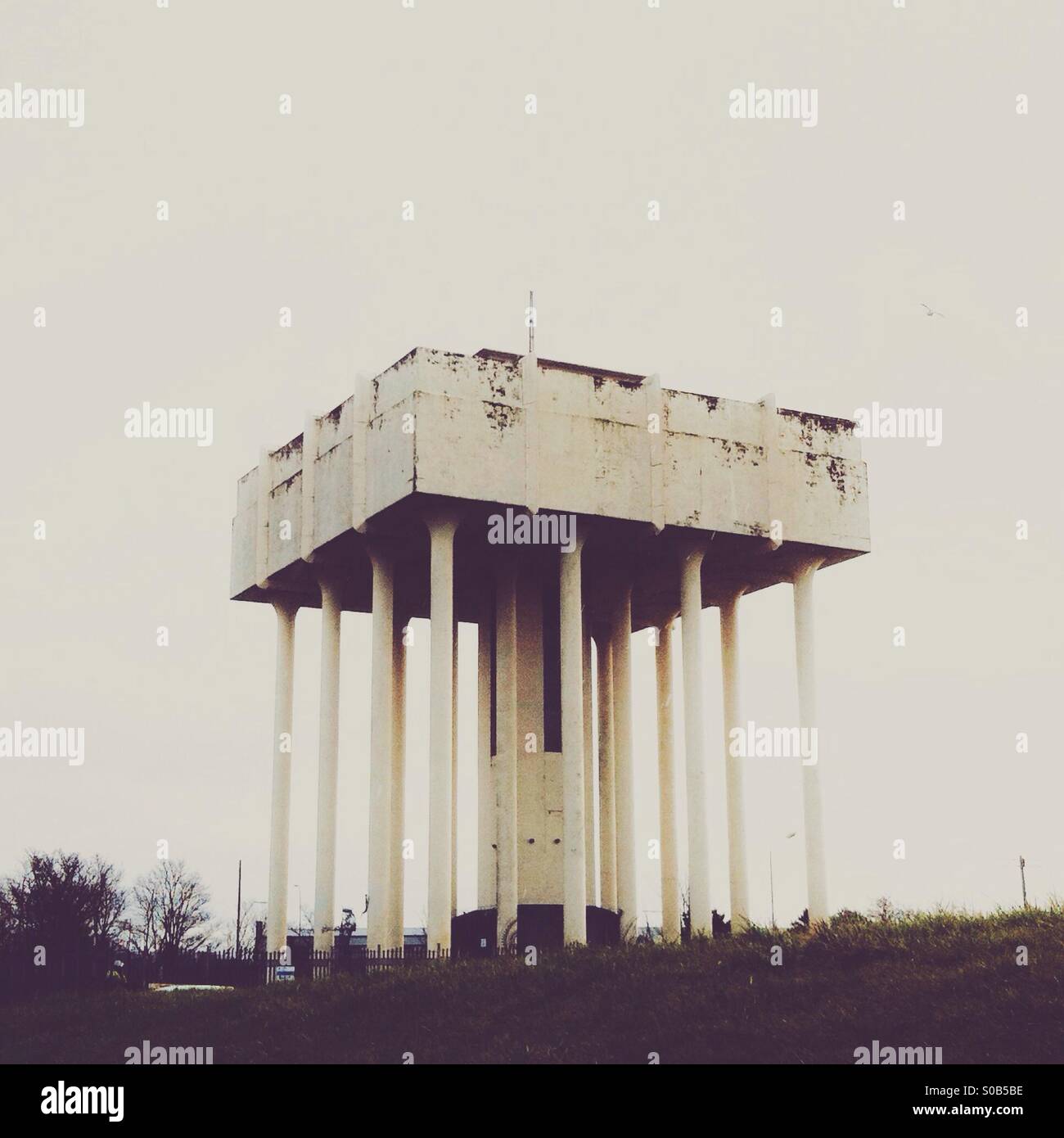 Water tower in muted tones and flat contrast. - Smartphone Captured Stock Image