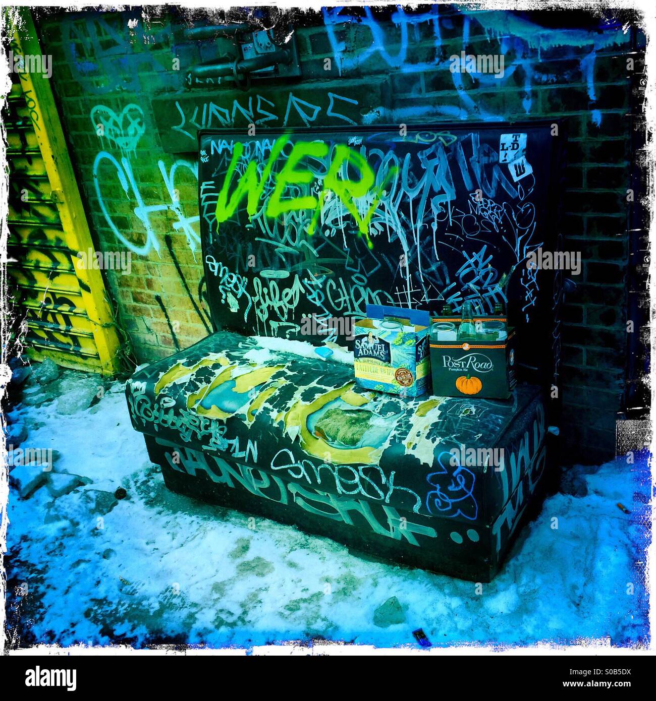 Old graffitied sofa outside bar in Williamsburg, Brooklyn. Stock Photo