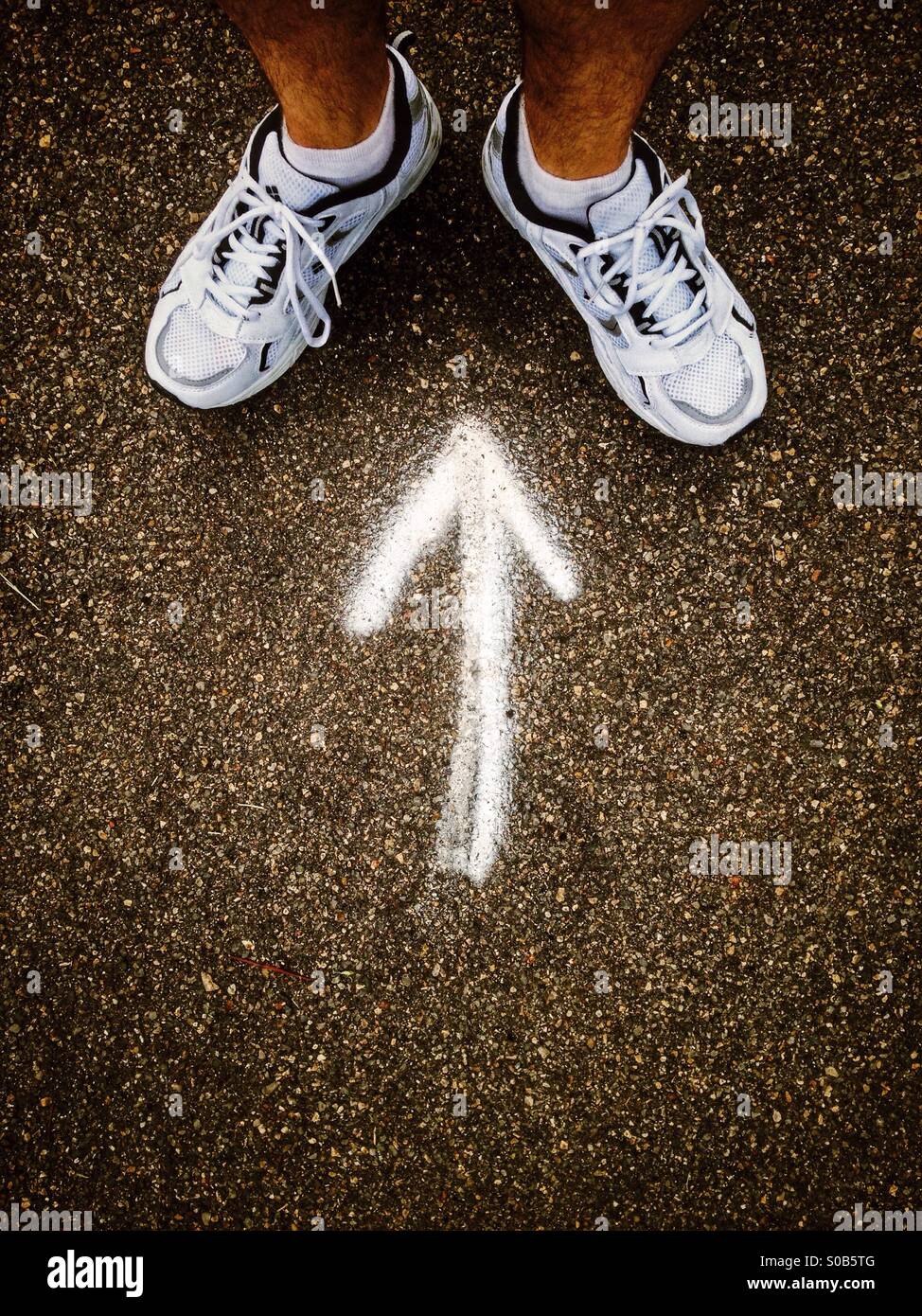 Arrow pointing to a man's feet. - Smartphone Captured Stock Image