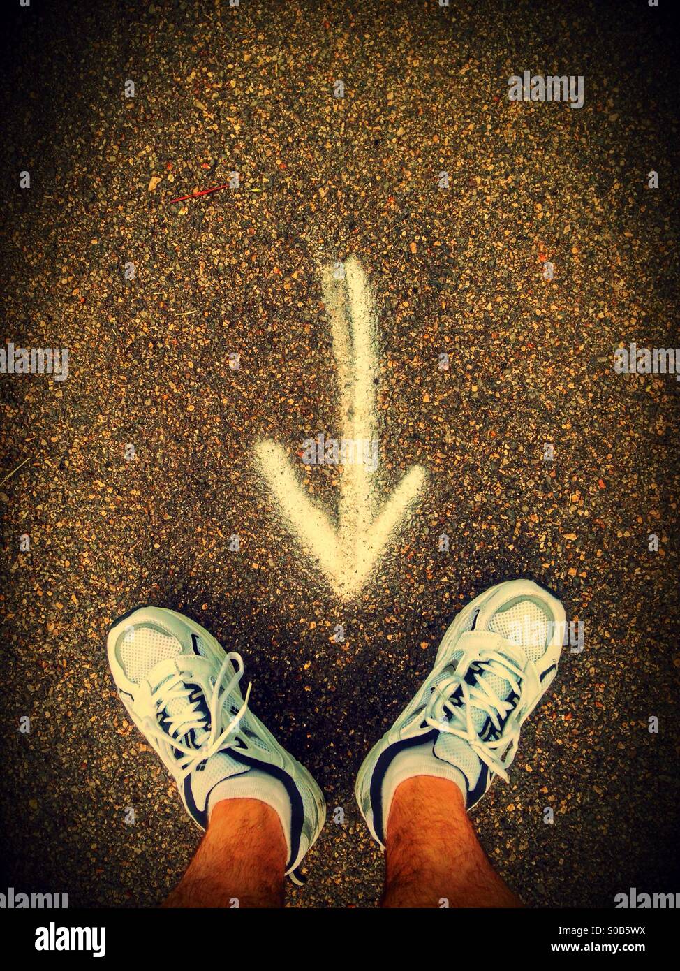 Arrow pointing to a man's feet. - Smartphone Captured Stock Image