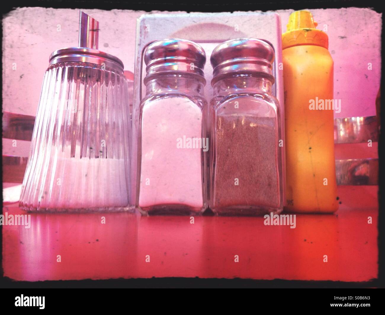 Close up of bottles of pink salt and pepper in containers with grinder  prepared. Stock Photo by puhimec