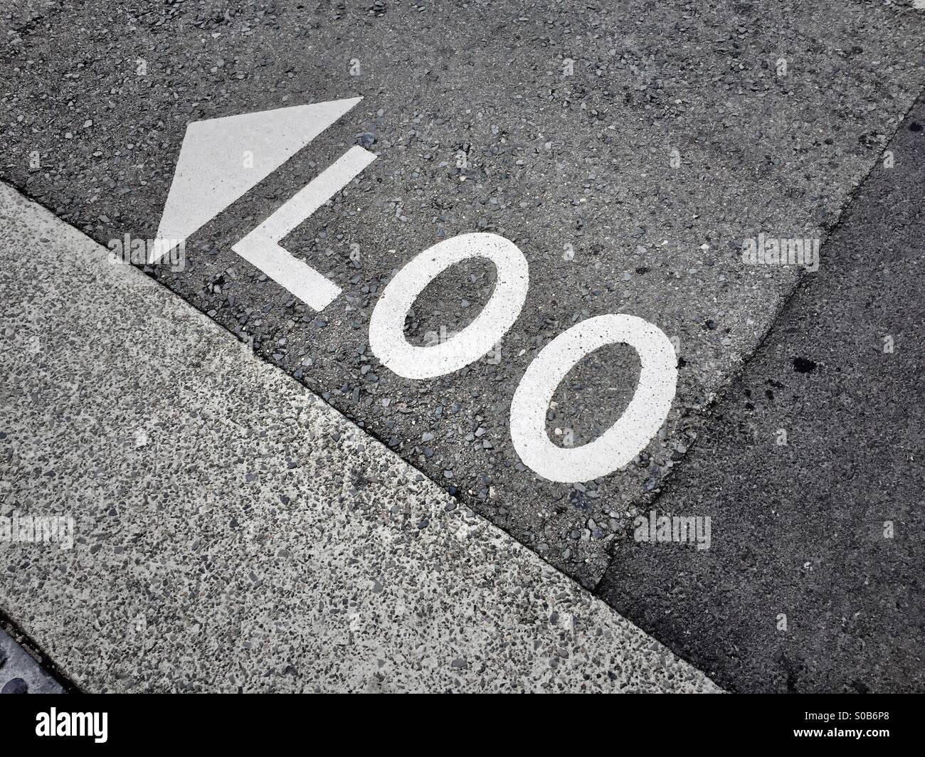 A 'Look' road marking that are now a 'Loo' due to road repairs Stock Photo