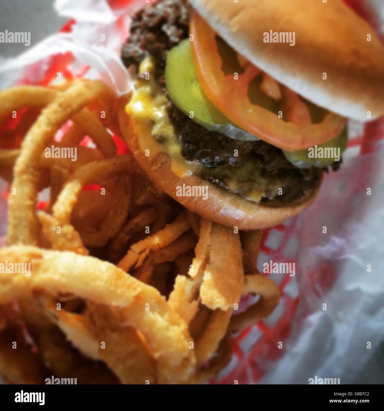 Drive-in burger and onion rings. Stock Photo