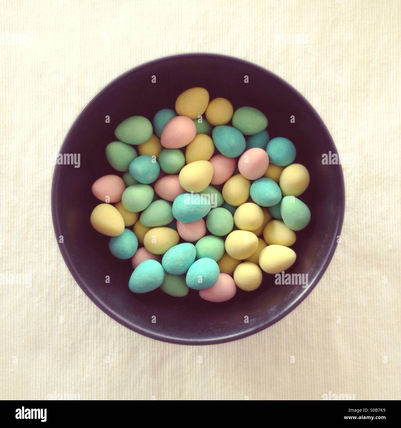 Bowl of sugar-coated chocolate Easter eggs, with subtle dreamy filter. - Smartphone Captured Stock Image