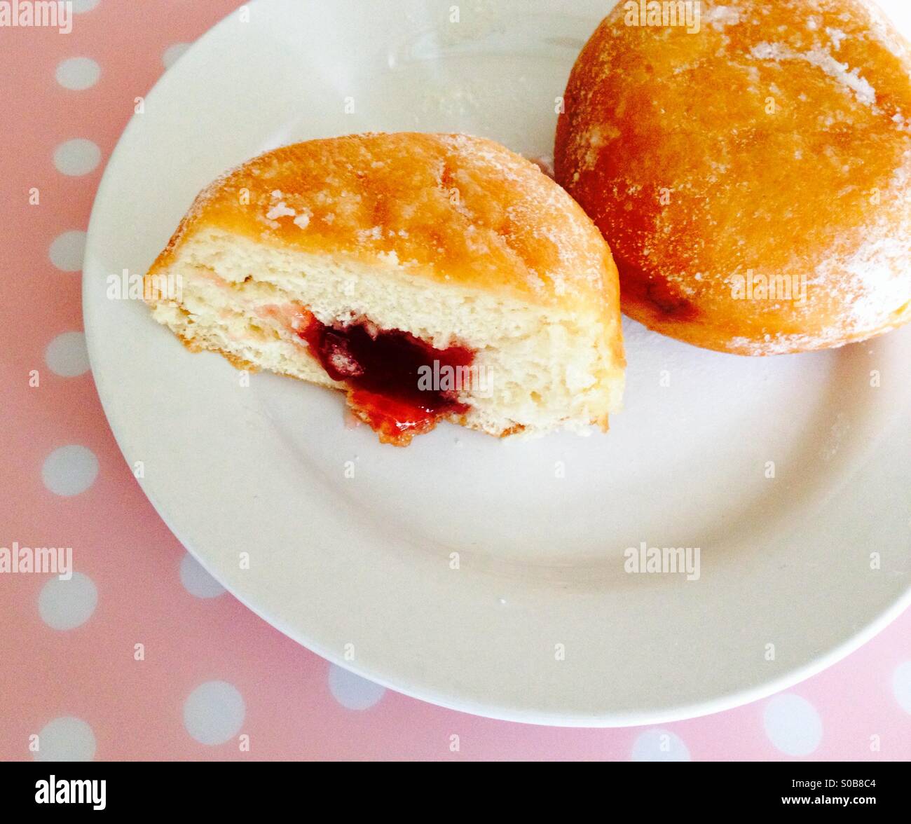 Jam filled doughnut on a white plate - Smartphone Captured Stock Image
