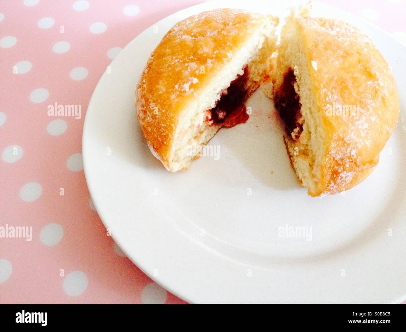 Jam filled doughnut on a white plate - Smartphone Captured Stock Image