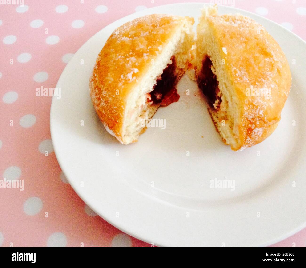 Jam filled doughnut on a white plate - Smartphone Captured Stock Image
