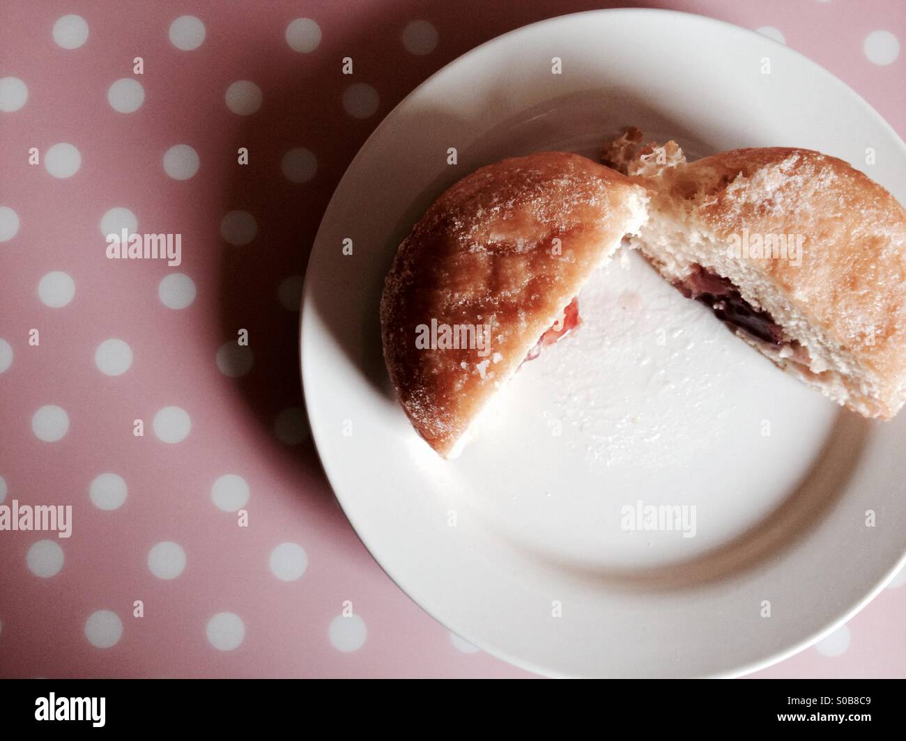 Jam filled doughnut on a white plate - Smartphone Captured Stock Image