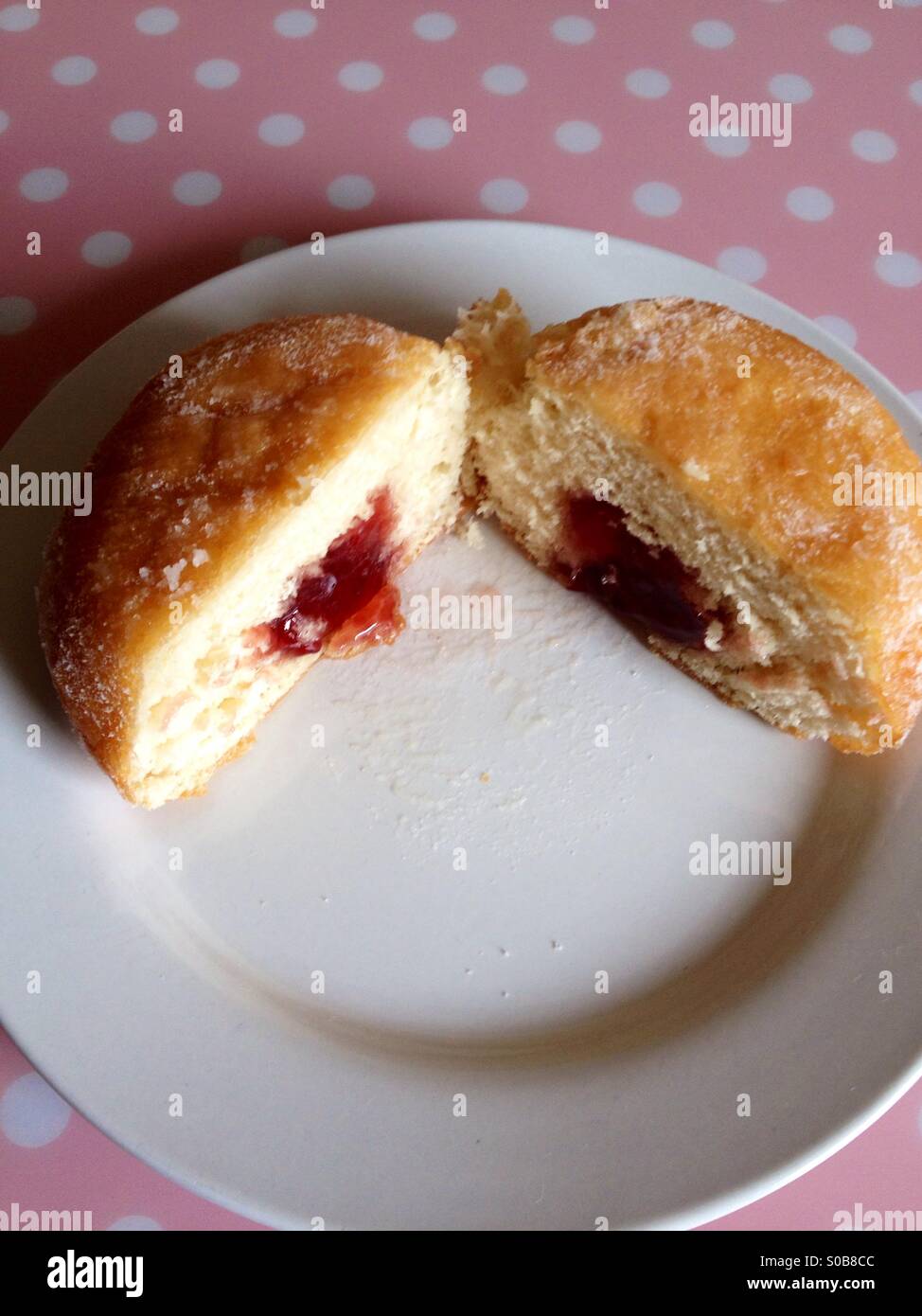 Jam filled doughnut on a white plate - Smartphone Captured Stock Image