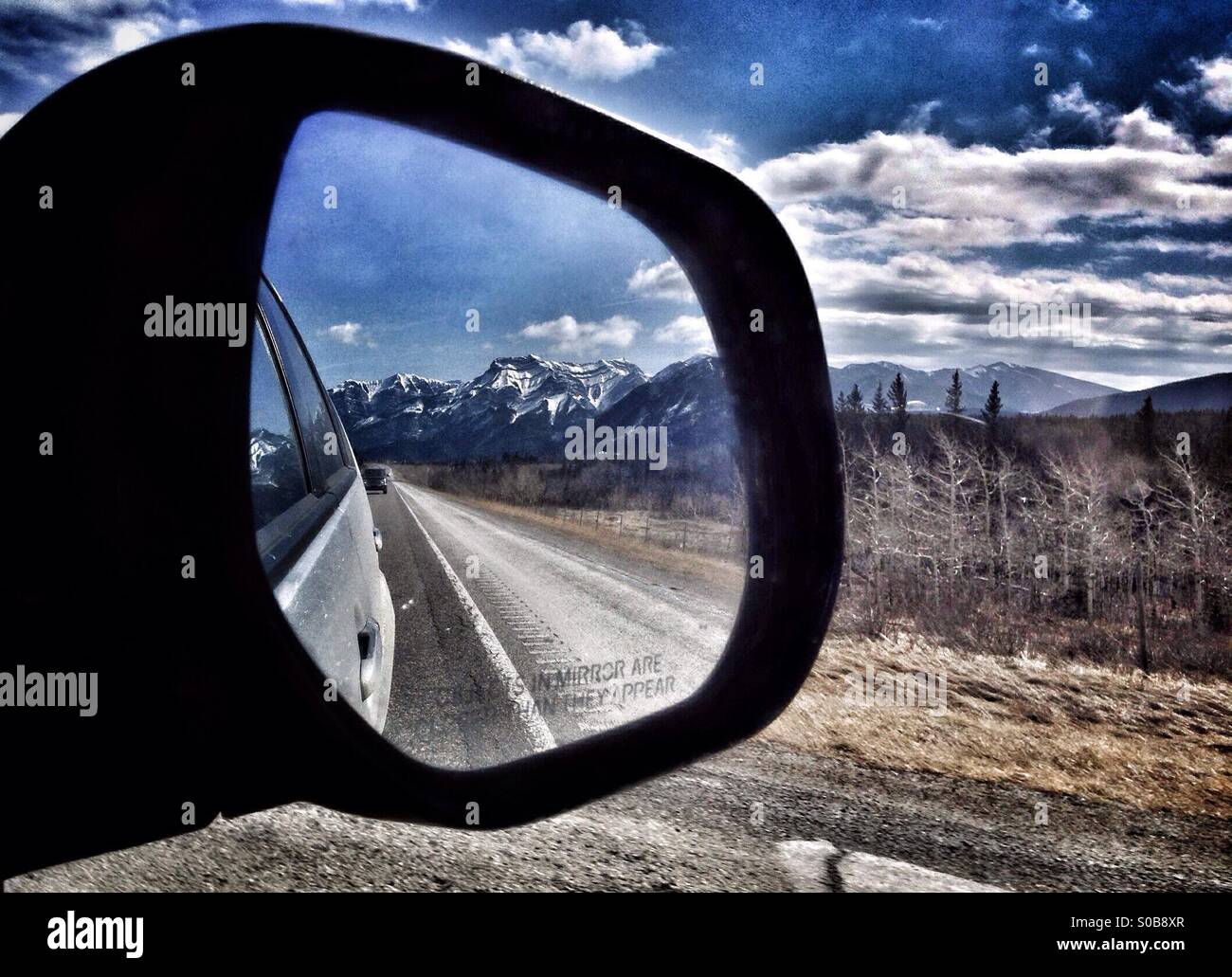 Reflection of mountains in a car wing mirror. - Smartphone Captured Stock Image