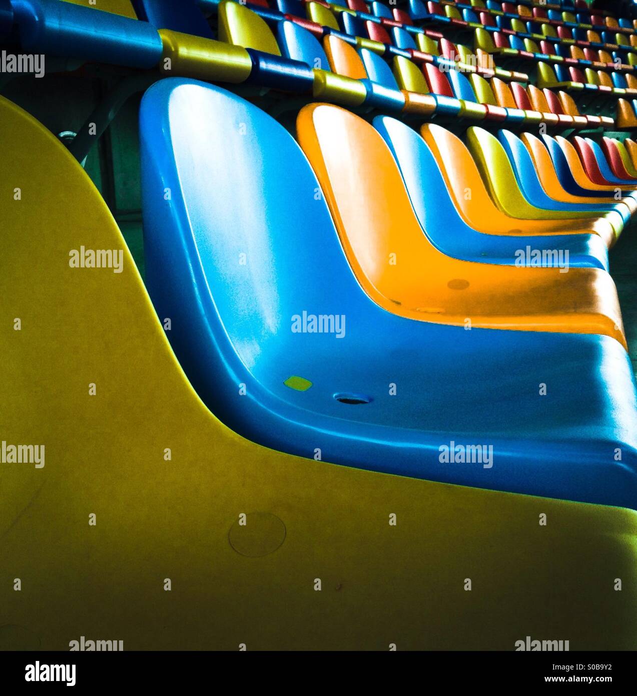 Empty colorful seats in a stadium near Barcelona, Catalonia, Spain - Smartphone Captured Stock Image