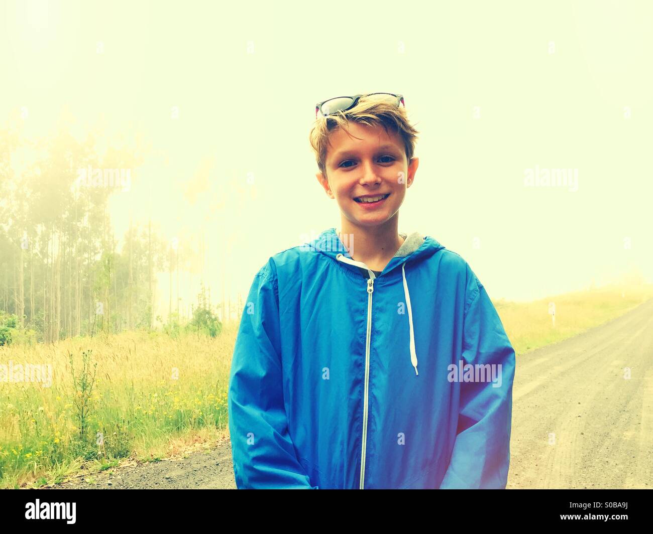A smiling 11 year old boy photographed whilst out for a walk - Smartphone Captured Stock Image