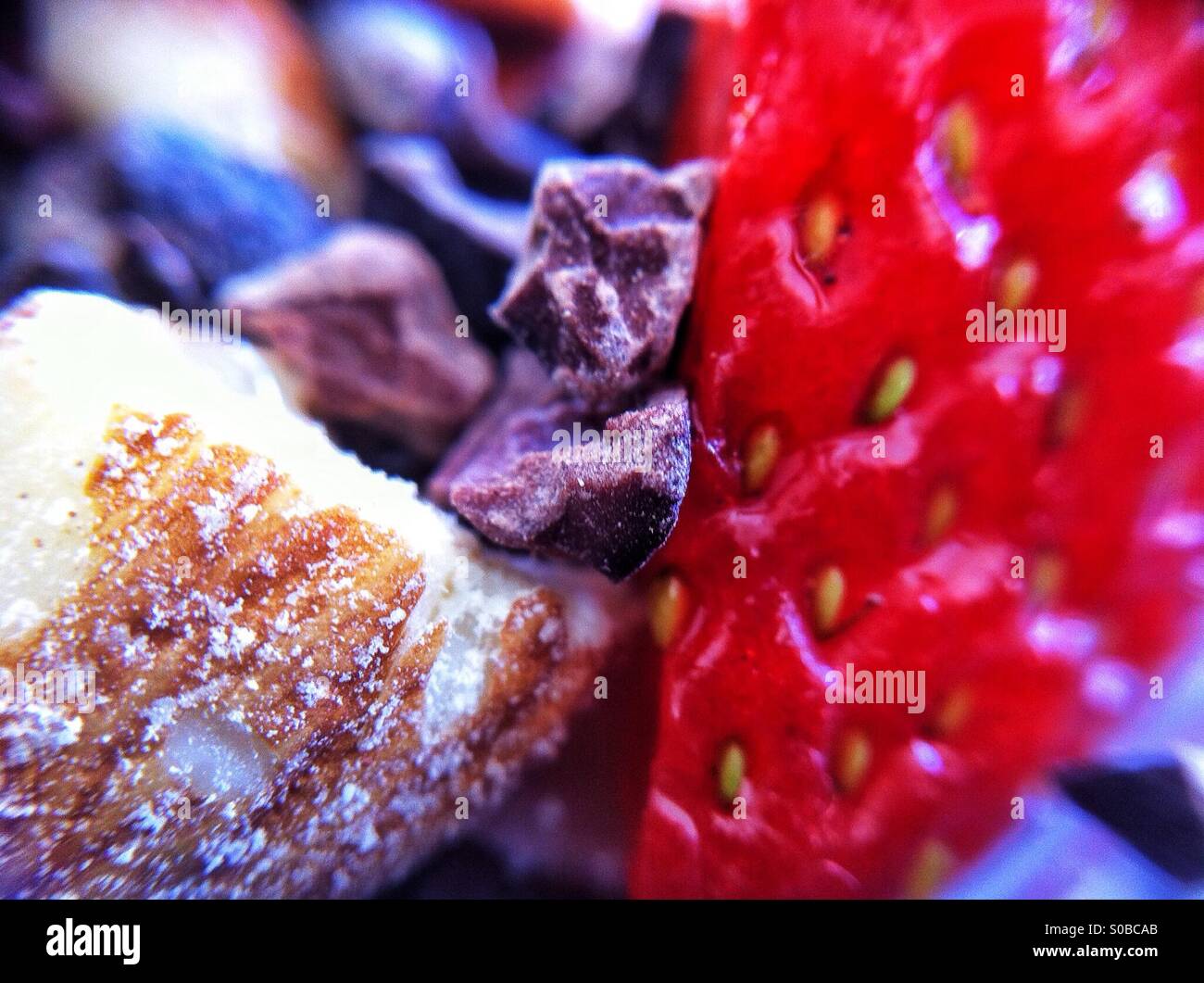Macro of almond nut, strawberry and chocolate topping on granola - Smartphone Captured Stock Image