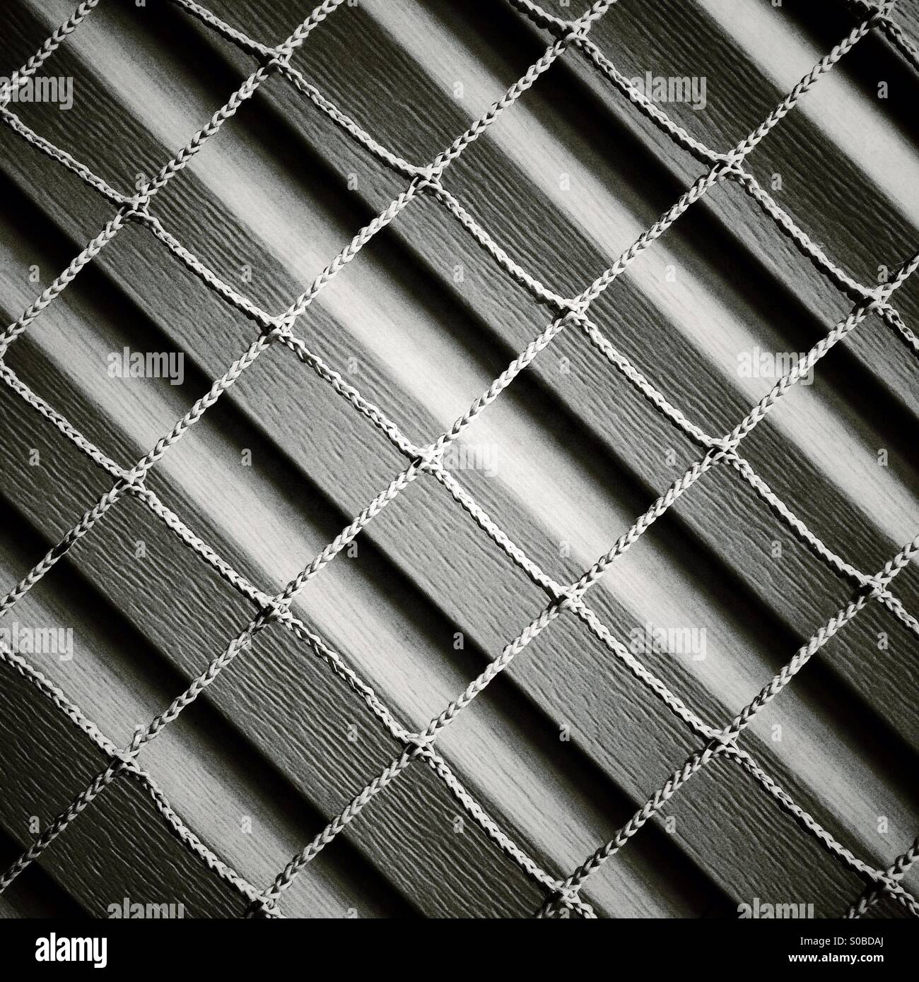 Abstract taken from a hockey net against the siding of a house. Stock Photo