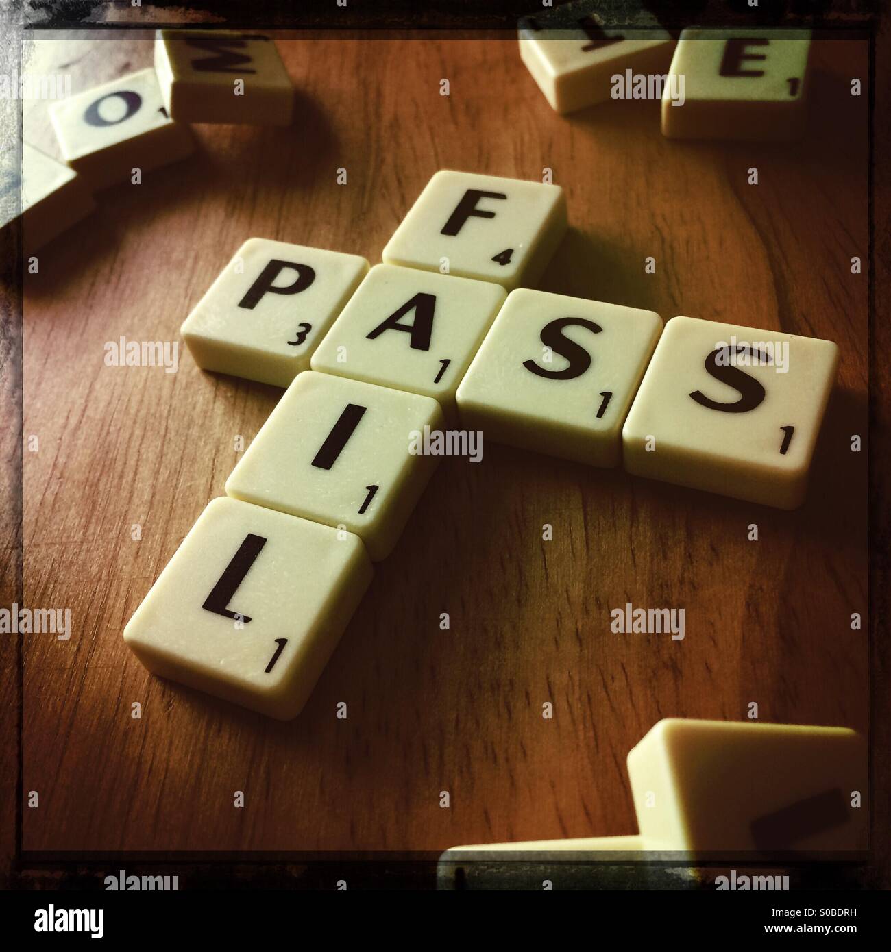 PASS & FAIL spelled out in scrabble tiles Stock Photo