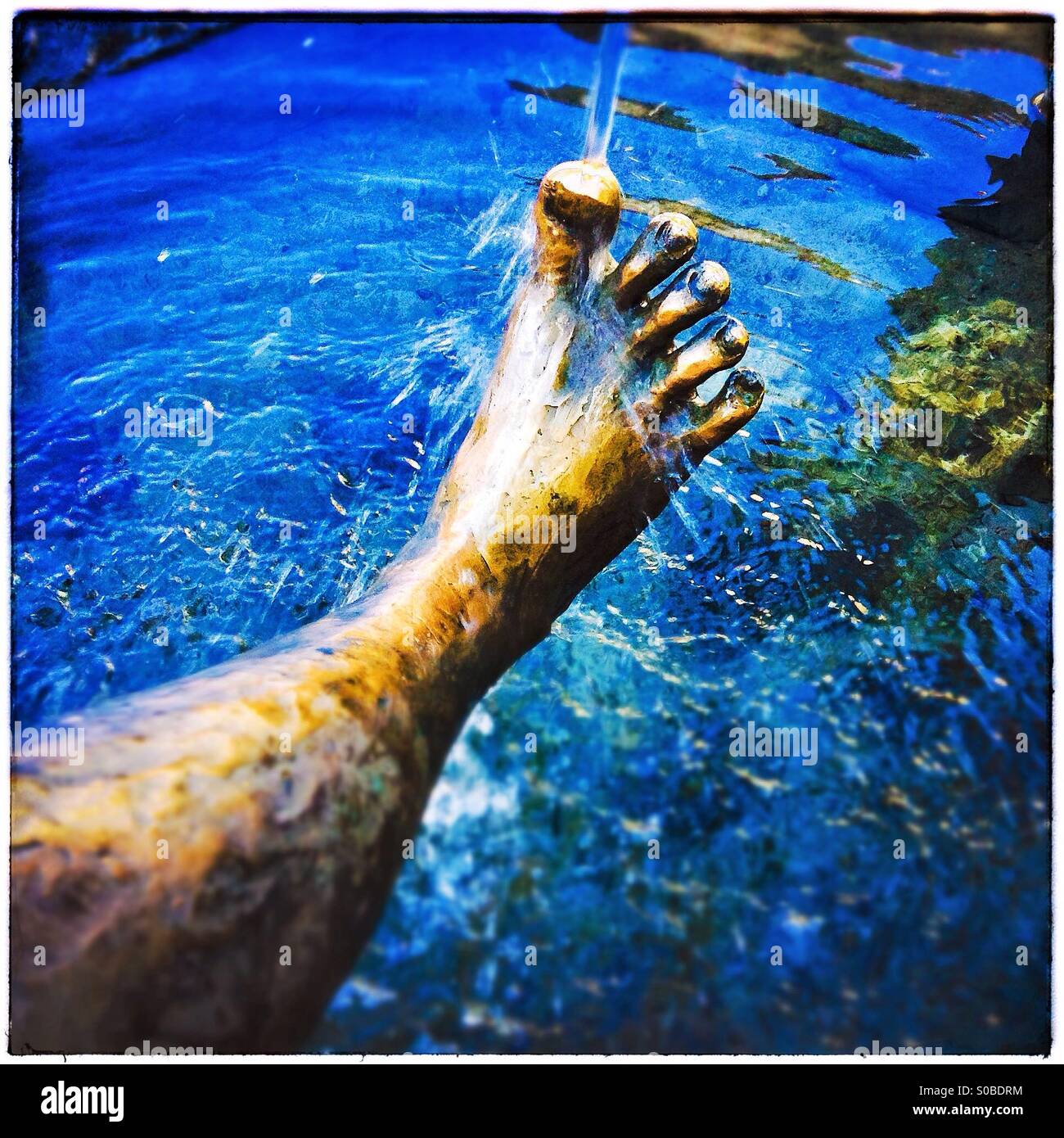 Foot sculpture throught water. Füssen, Bayern, Deutschland Stock Photo