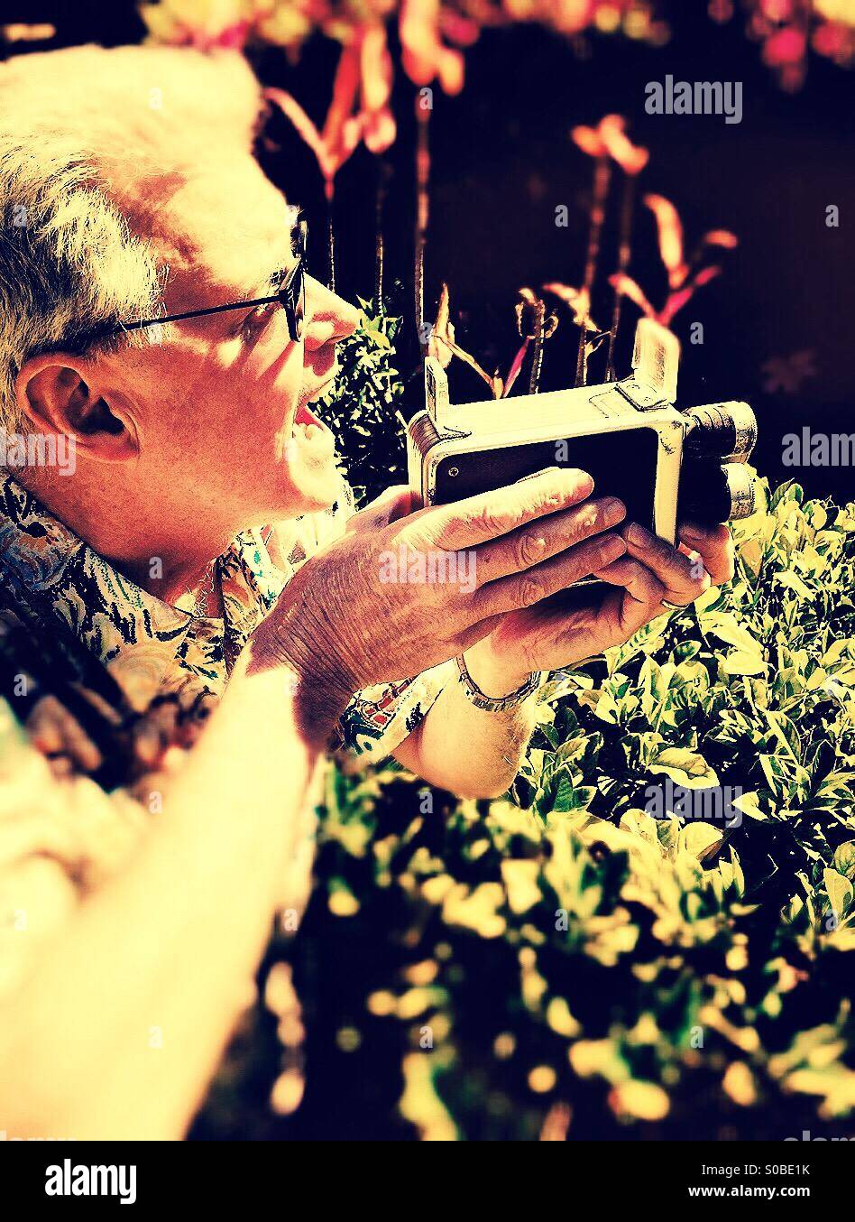 Man with vintage movie camera - Smartphone Captured Stock Image