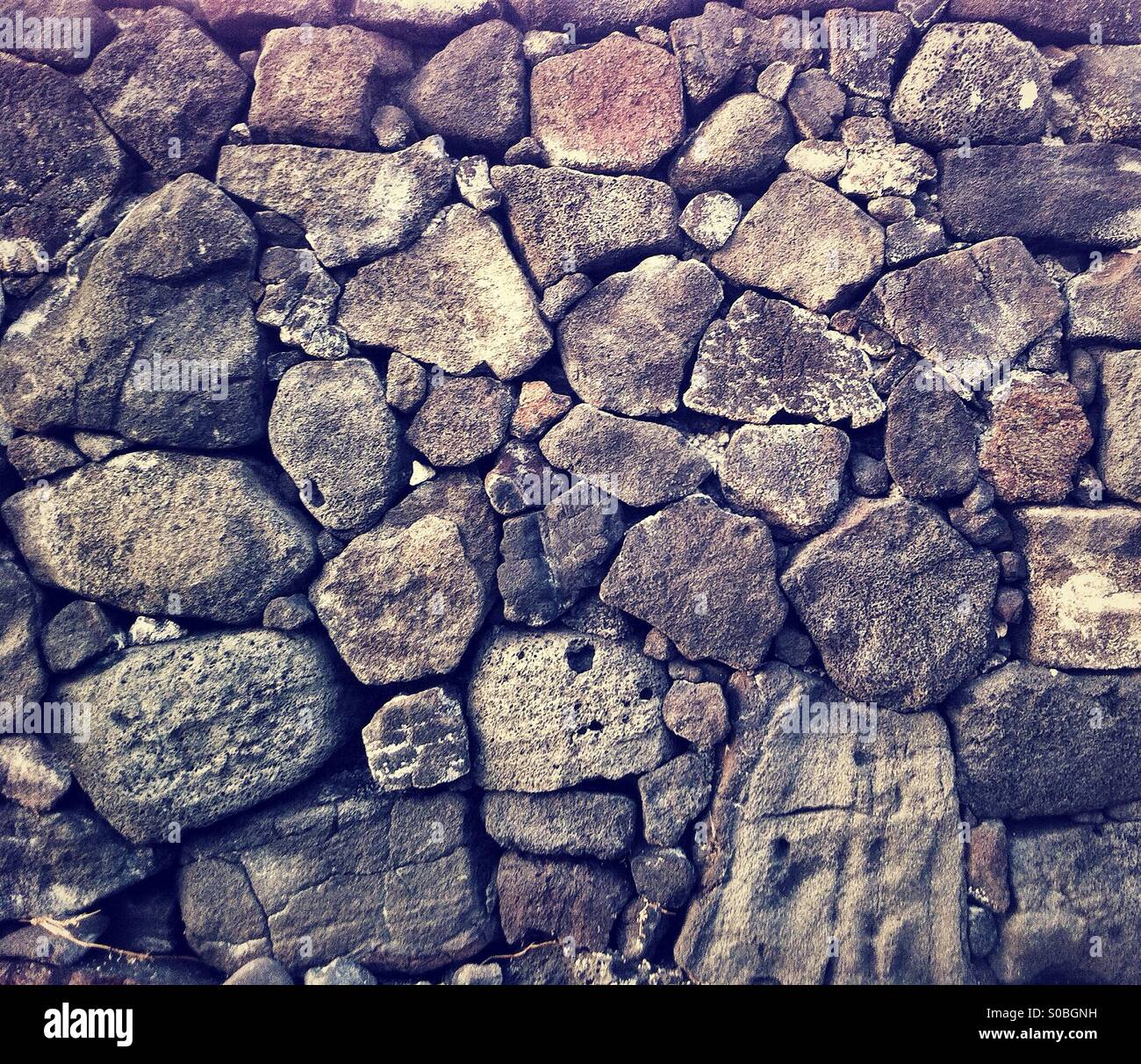 wall of ancient hawaiian Heiau or sacred place made out of lava rocks - Smartphone Captured Stock Image