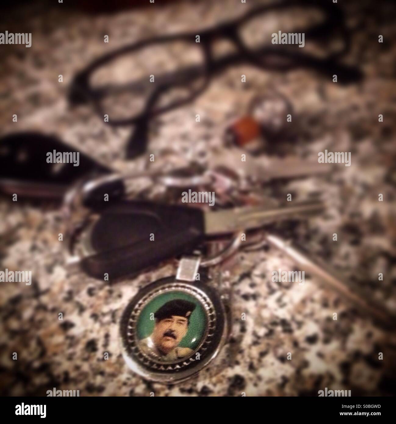 A key chain with Sadam Hussein's portrait in a restaurant of Mexico City, Mexico - Smartphone Captured Stock Image