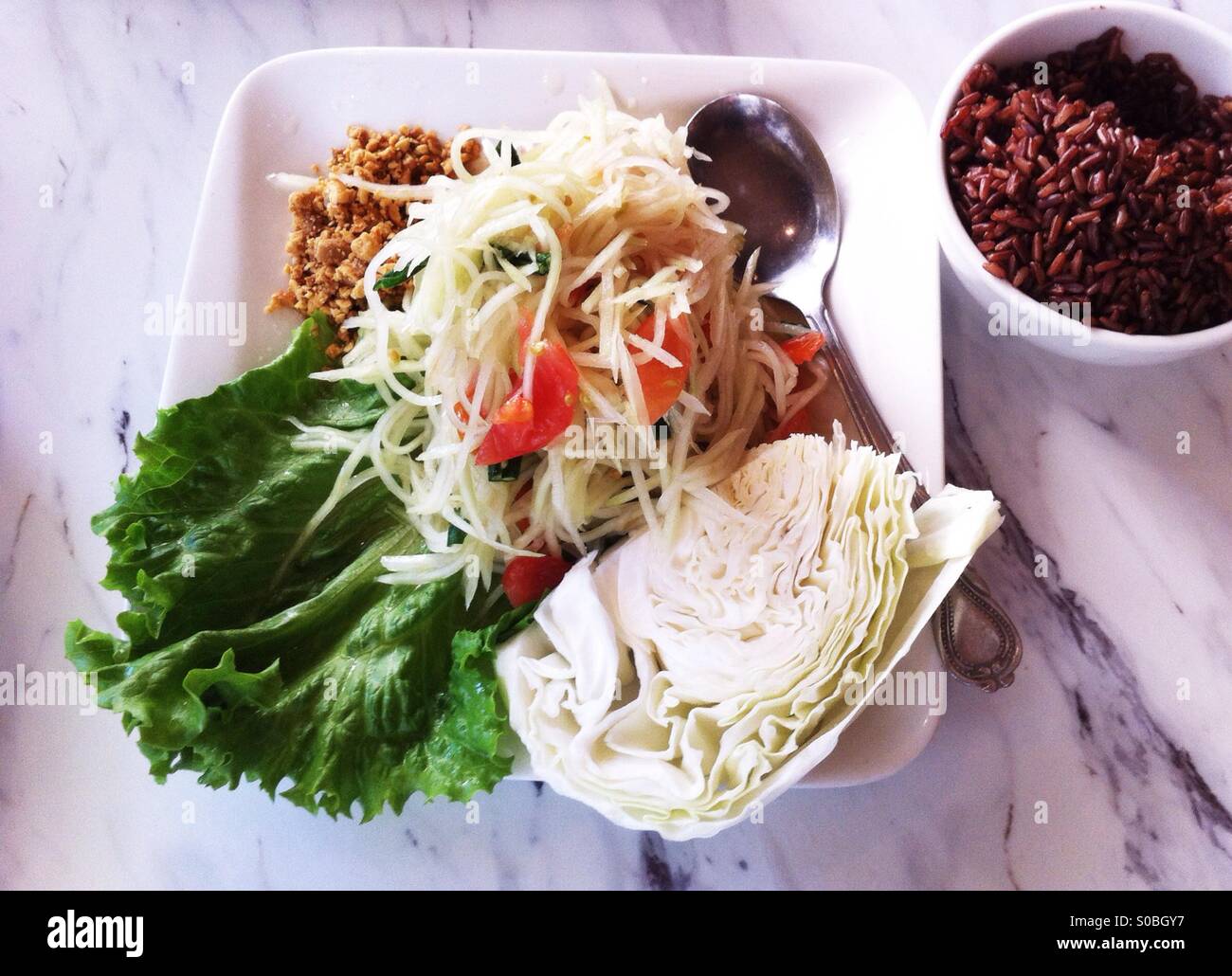 fresh papaya salad with cabbage and brown rice - Smartphone Captured Stock Image