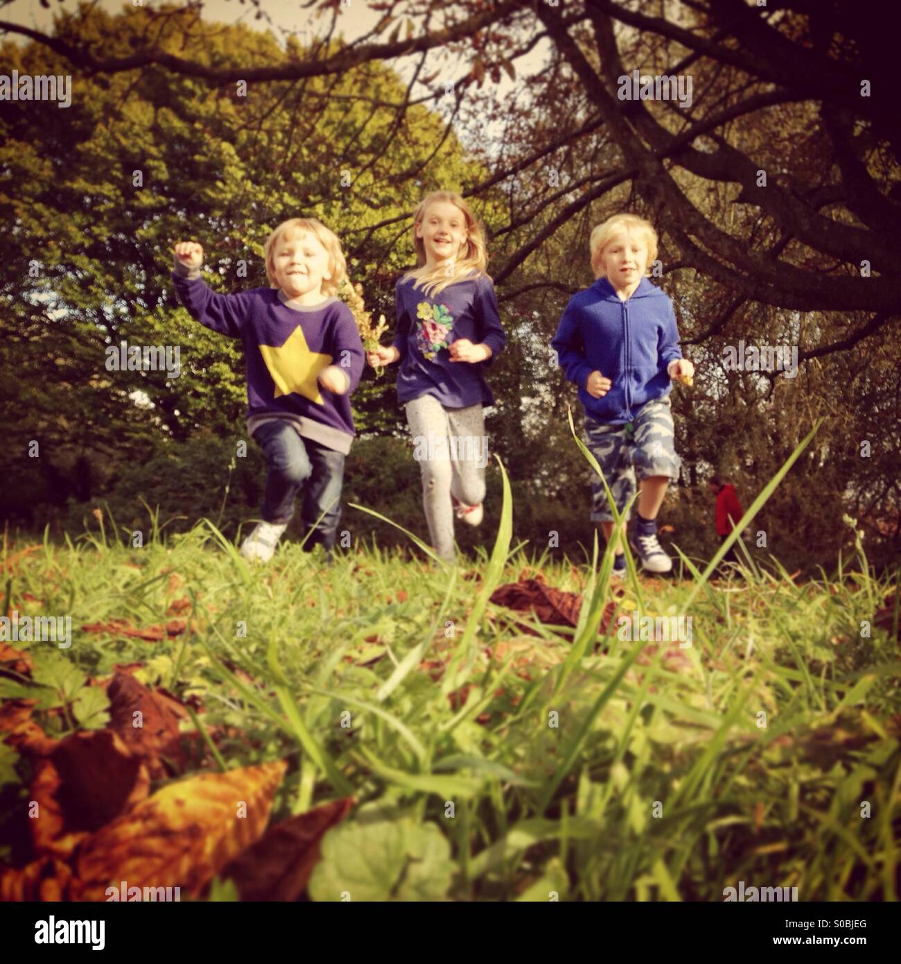 Three Children Running Stock Photo