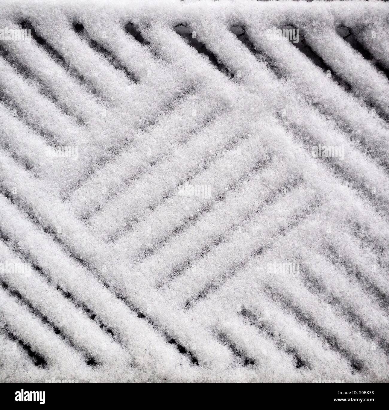 Abstract of fresh snow on a bristly doormat. - Smartphone Captured Stock Image
