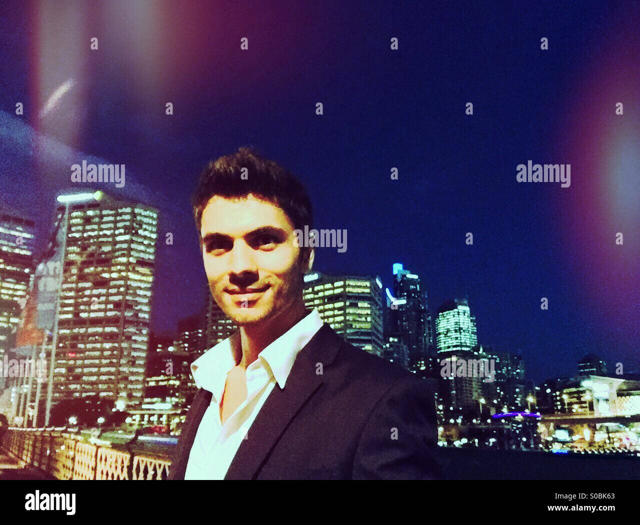 A young man in the city at night - Smartphone Captured Stock Image