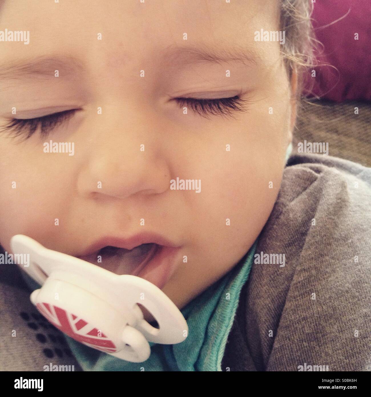 Baby sleeping with soother in mouth Stock Photo Alamy