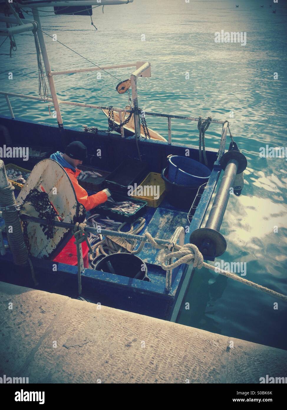 Fisherman working on boat Stock Photo
