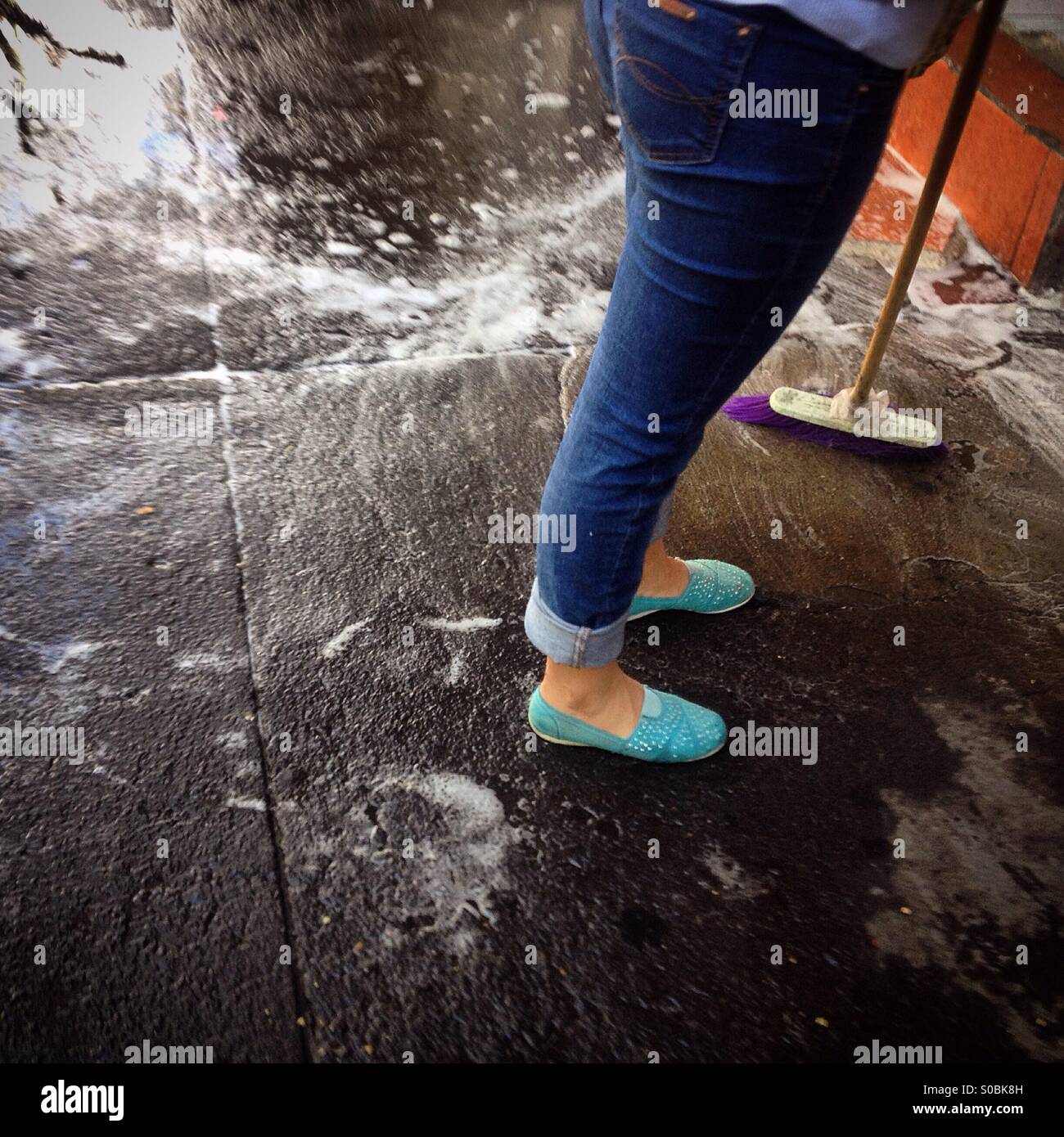 A woman cleans the street in Colonia Roma, Mexico City, Mexico Stock Photo