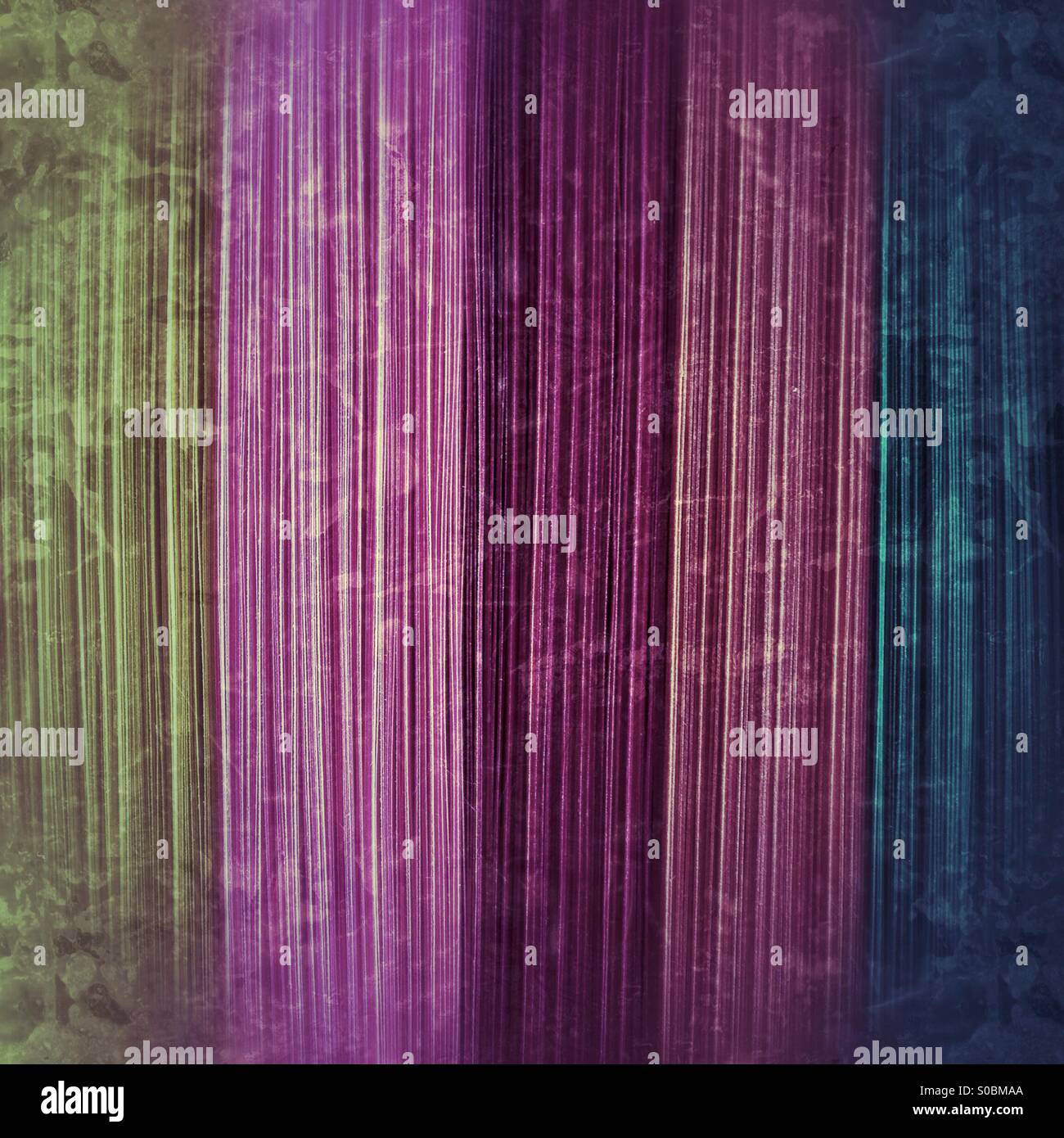 Abstract image taken from a stack of multi-coloured paper, given a grungey-antique look. - Smartphone Captured Stock Image