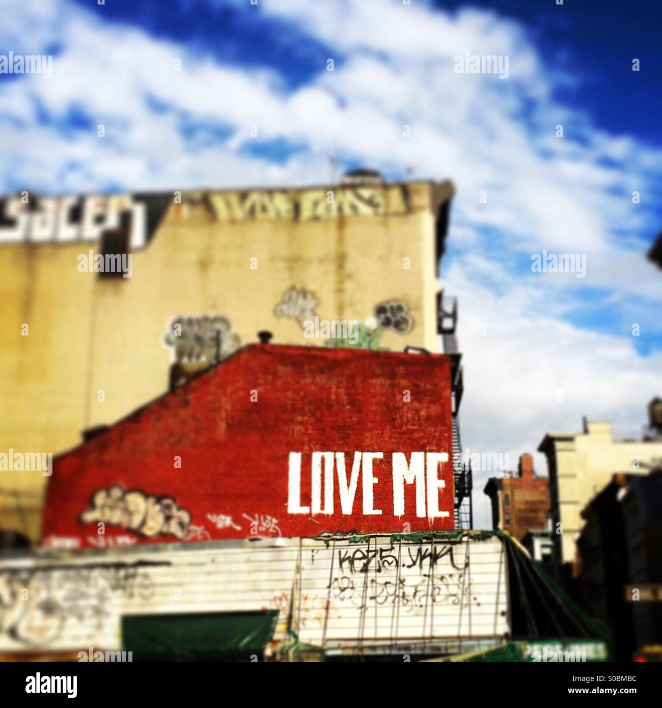 'Love Me' graffiti on Canal Street in NYC Stock Photo