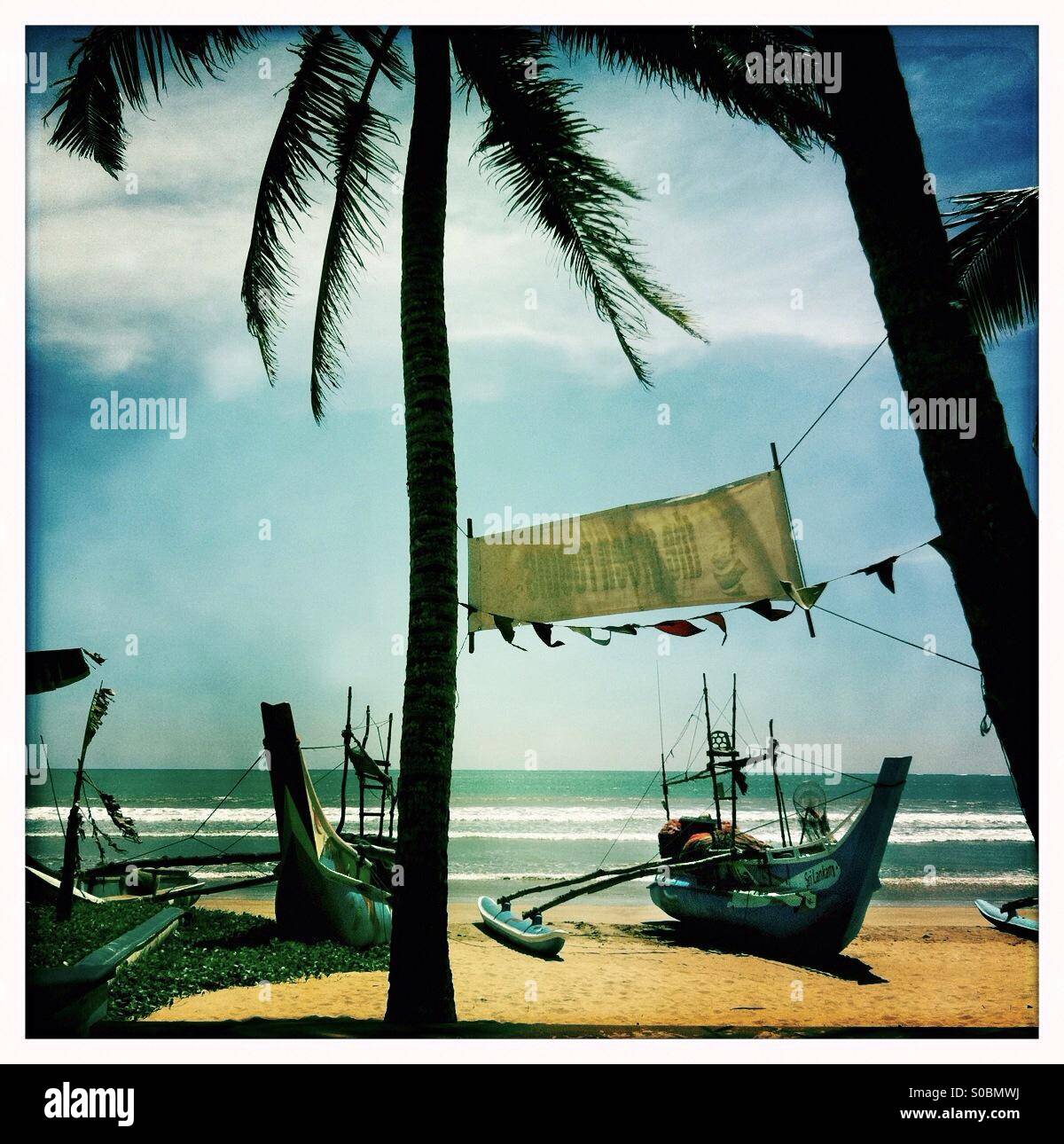 Beach, palm trees and fishing boats at Weligama Bay, Sri Lanka. - Smartphone Captured Stock Image