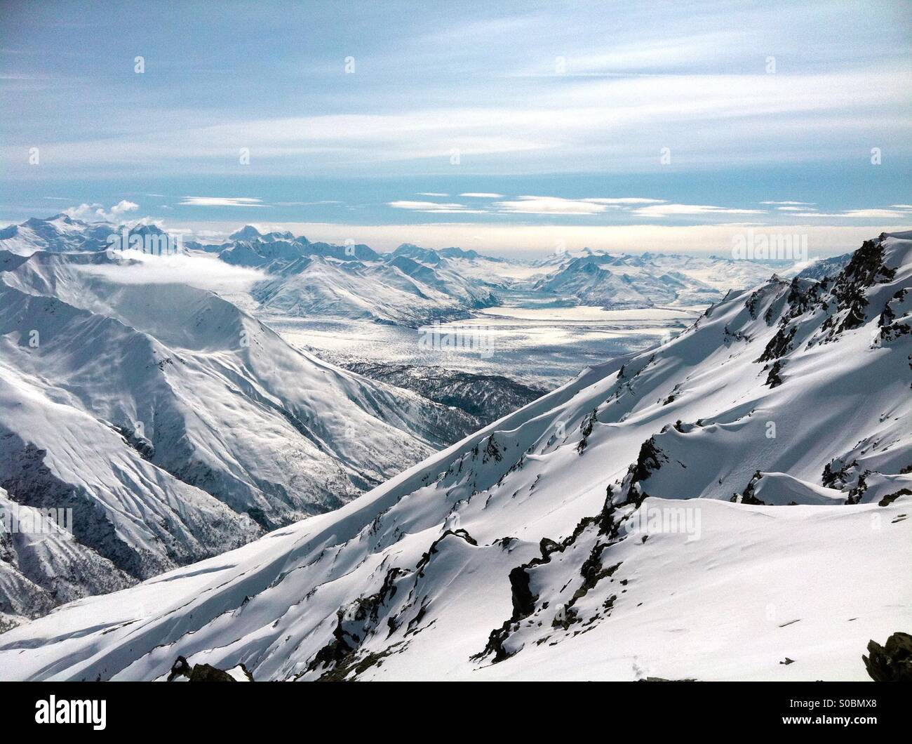 Snowy mountains in the Chugach Mountains in Alaska with Knik River and glacier. Stock Photo