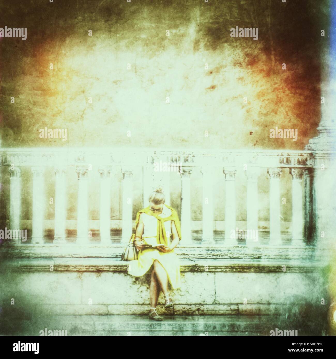 Woman reading in public square - Smartphone Captured Stock Image